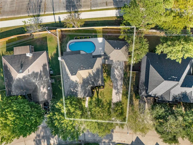 an aerial view of a house with a yard and fountain
