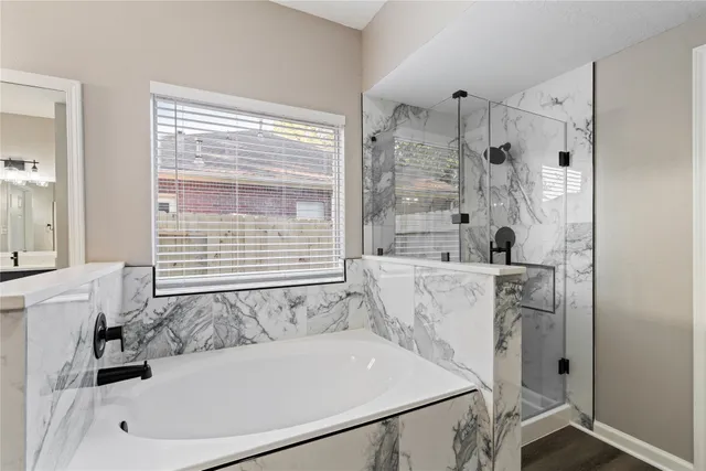 a bathroom with a bathtub and a shower