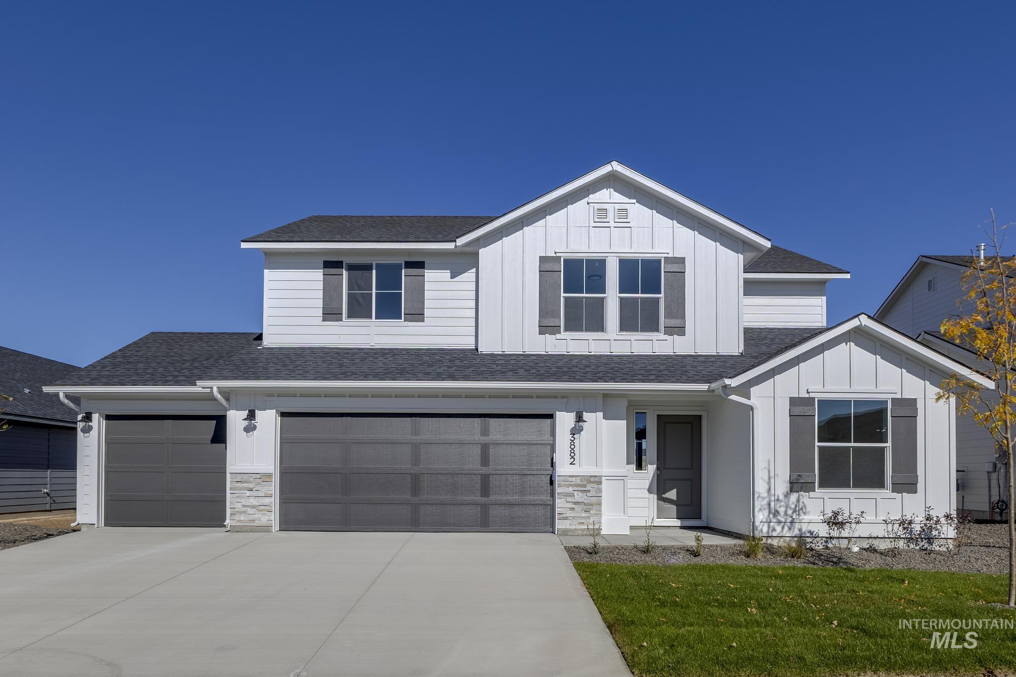 3882 West Maypearl Street Meridian, ID 83642 - Photo 1 of 1 View of front of property with a shingled roof, board and batten siding, concrete driveway, and a front lawn