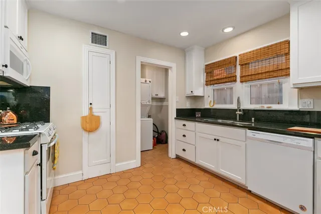 a spacious bathroom with a granite countertop sink and a mirror