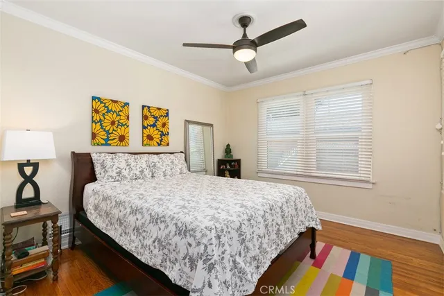 a bedroom with a bed dresser and a window