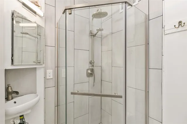 a bathroom with a shower and a sink