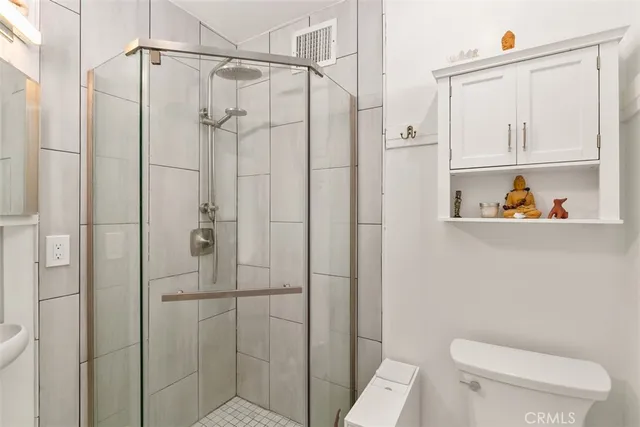 a bathroom with a shower a toilet and sink