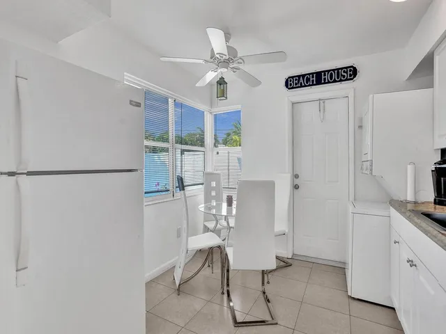 a view of a porch with a table and chairs