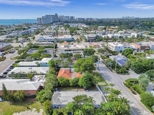 an aerial view of residential houses with outdoor space