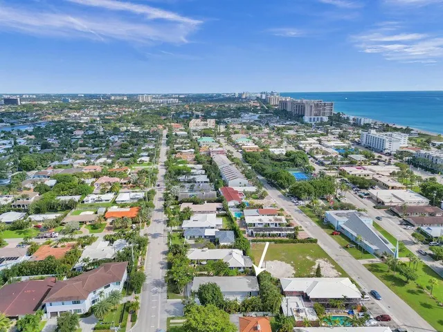 a view of a house with a yard and a garage