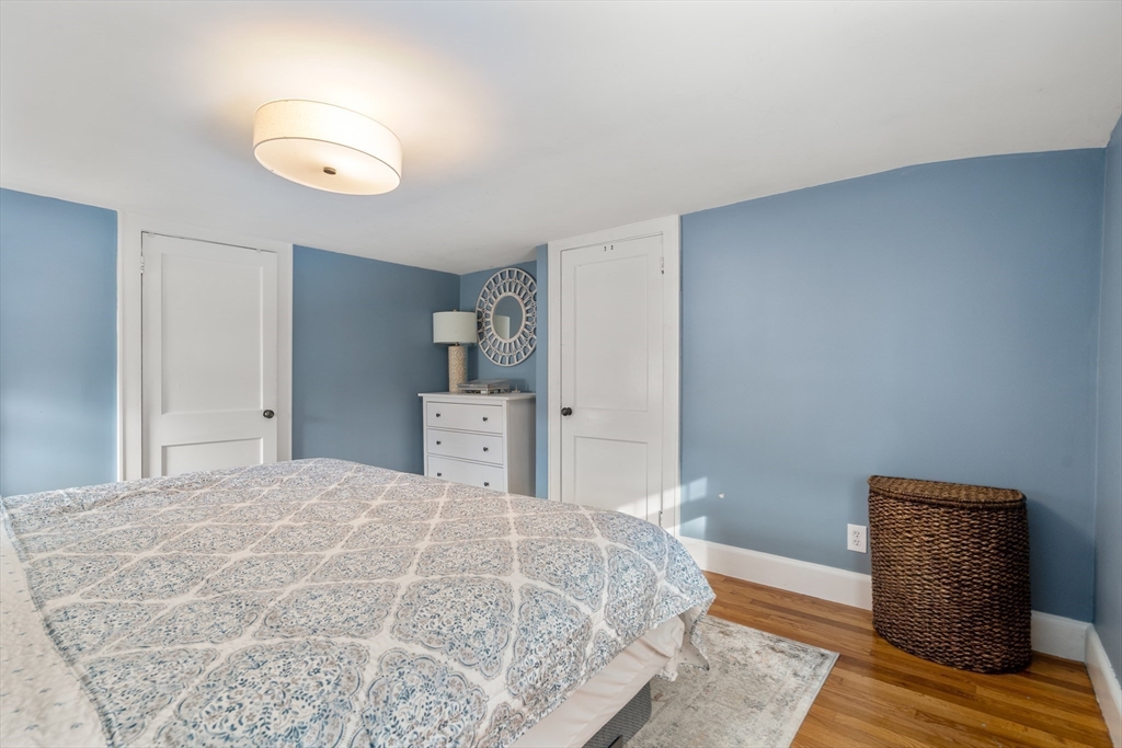 21 Summer Street Sudbury, MA 01776 - Photo 15 of 24 a bedroom with a bed and wooden floor