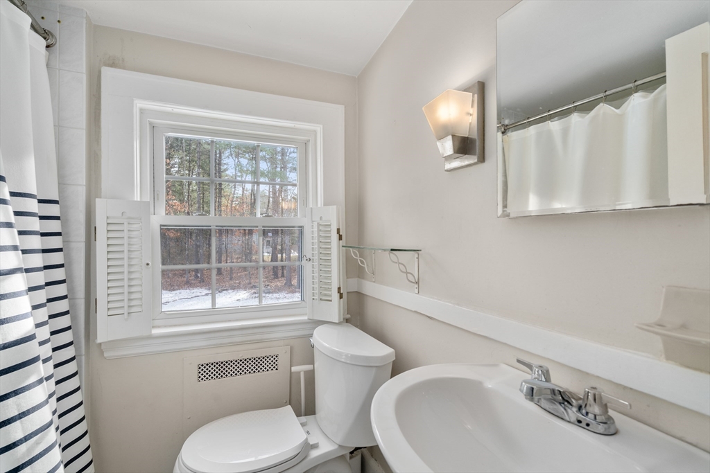 21 Summer Street Sudbury, MA 01776 - Photo 18 of 24 a white toilet sitting next to a bathroom sink