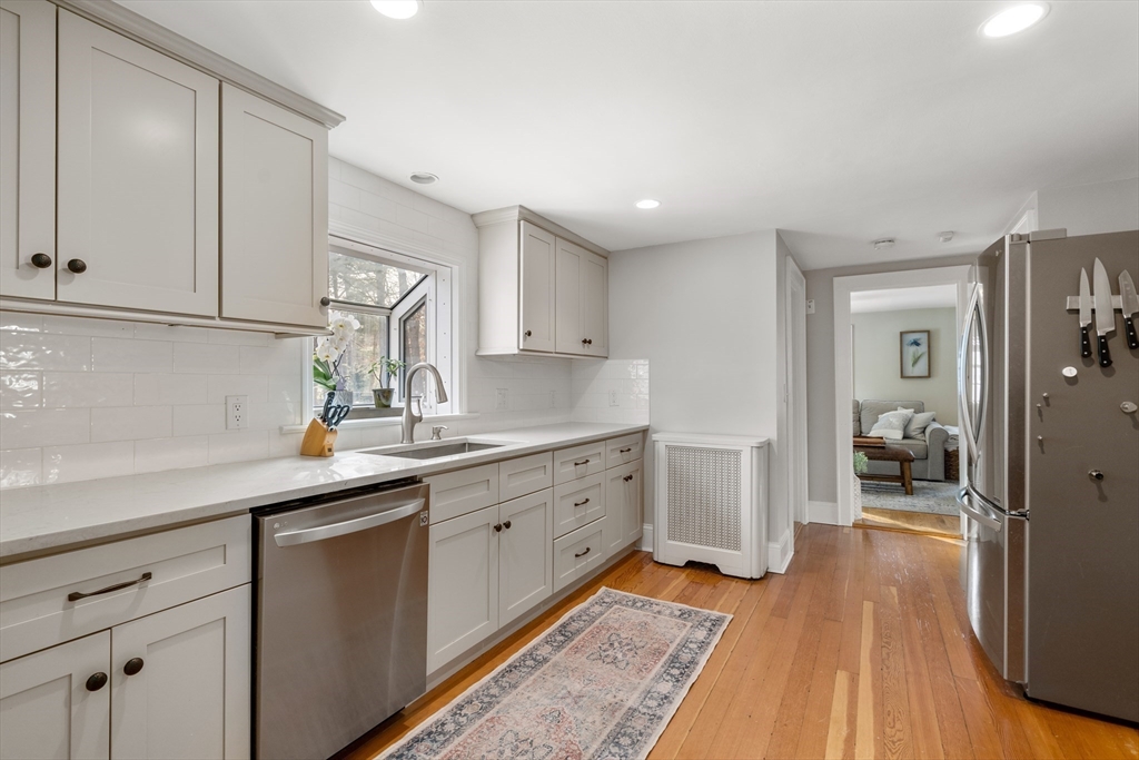 21 Summer Street Sudbury, MA 01776 - Photo 5 of 24 a kitchen with sink cabinets and wooden floor
