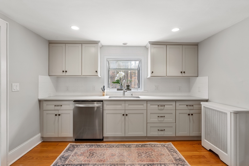 21 Summer Street Sudbury, MA 01776 - Photo 6 of 24 a kitchen with white cabinets appliances and a sink