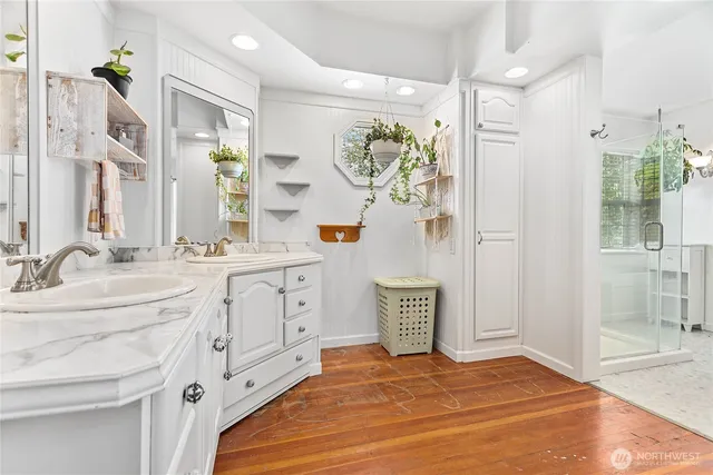a spacious bathroom with double sink and a mirror
