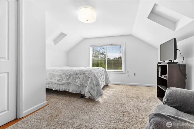 a spacious bedroom with a bed and a couch