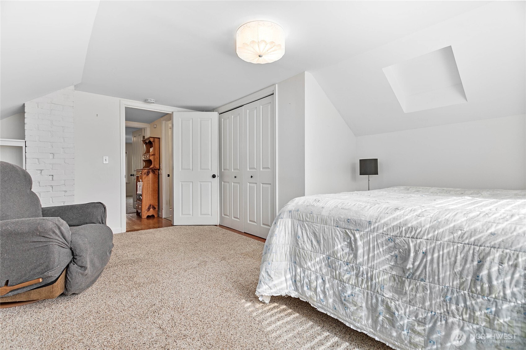 8731 Valley View Road Custer, WA 98240 - Photo 25 of 40 a spacious bedroom with a bed and a couch