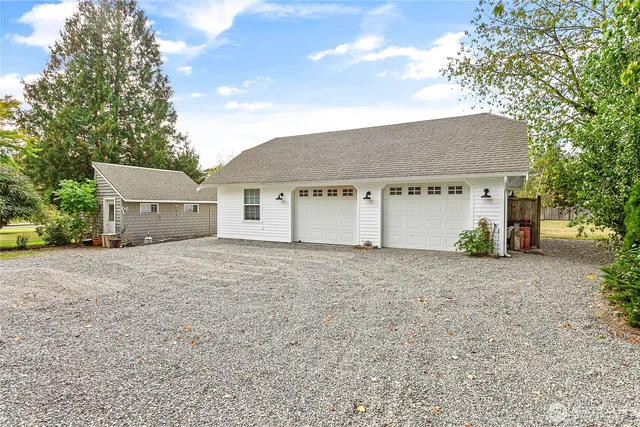 a view of backyard with outdoor seating and trees