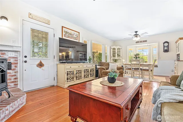 a living room with furniture and wooden floor