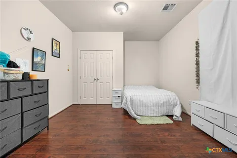 a view of a bedroom with closet and cabinet