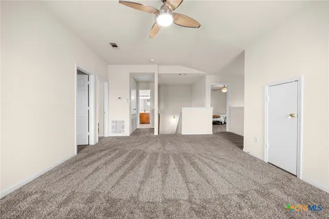 a view of empty room with a ceiling fan