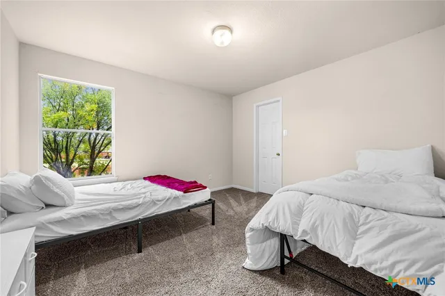 a bedroom with a bed and window