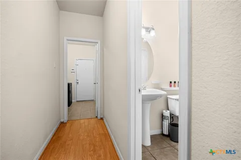 a view of a bathroom from a hallway