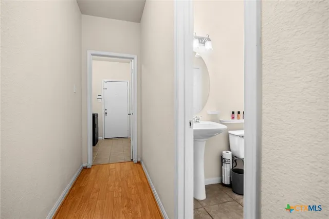 a view of a bathroom from a hallway