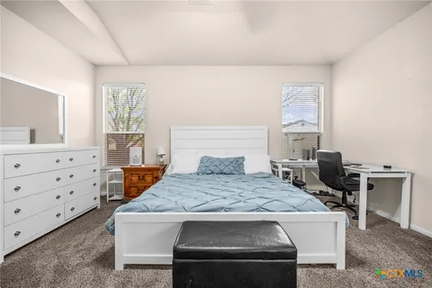 a living room with a table chairs and a dresser