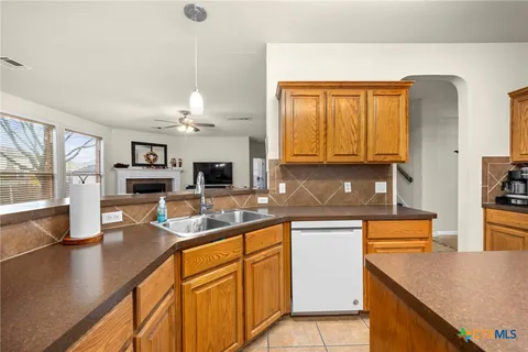 a kitchen with stainless steel appliances granite countertop a sink and a stove