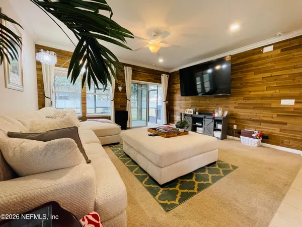 a bedroom with a bed window and a flat screen tv