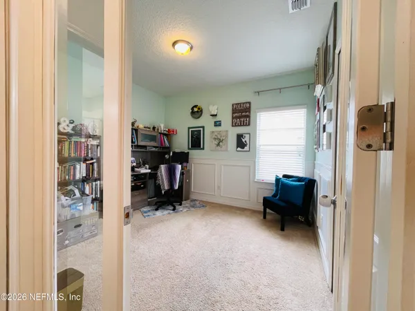 a view of room with workspace and windows