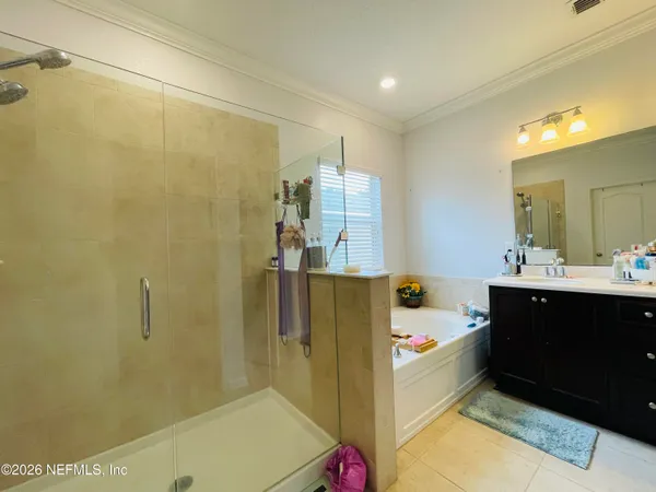 a bathroom with a sink vanity and tub