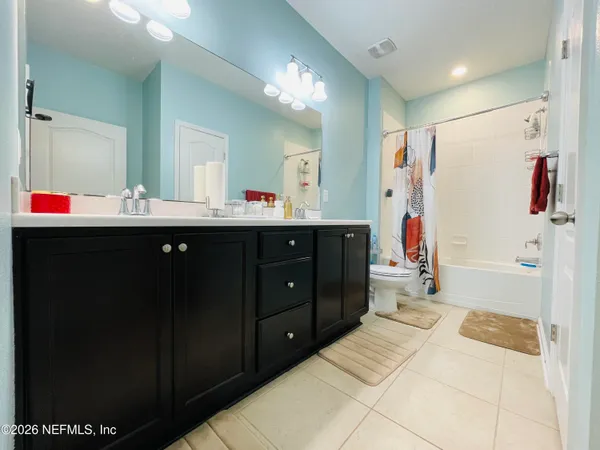 a spacious bathroom with a sink mirror and shower