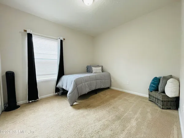 a bedroom with a bed and a chair