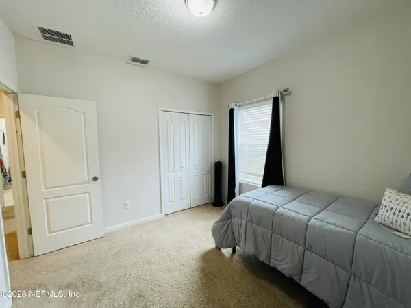 a bedroom with a bed and a window