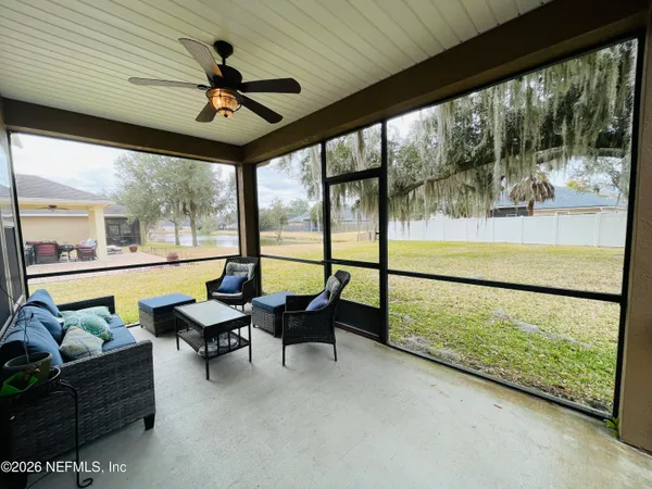 a living room with furniture and a floor to ceiling window