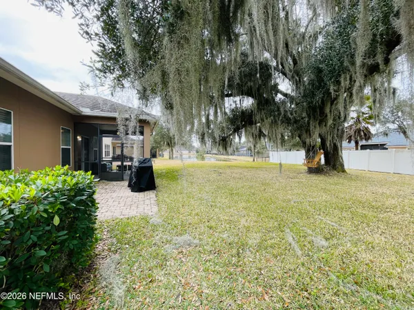 a view of a yard with palm trees