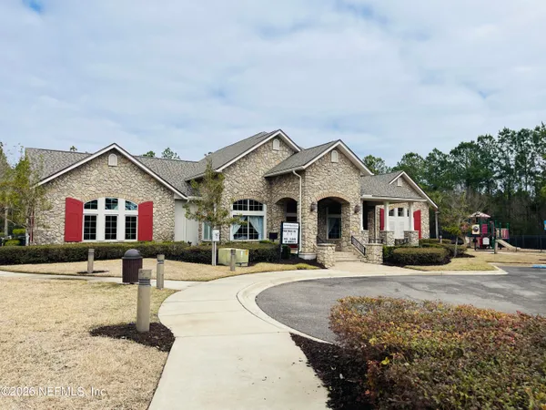 a front view of multiple houses with yard