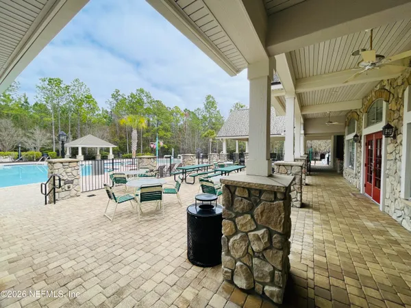 a outdoor space with lots of tables a garden view and chairs