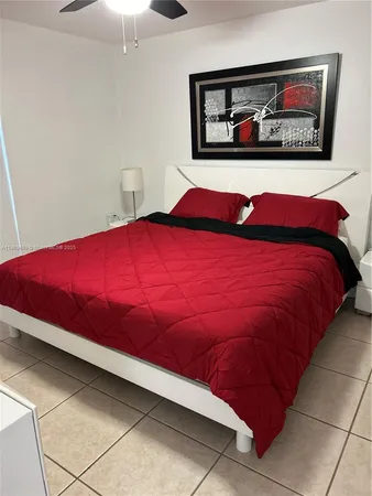 a bedroom with a bed and a painting on the wall