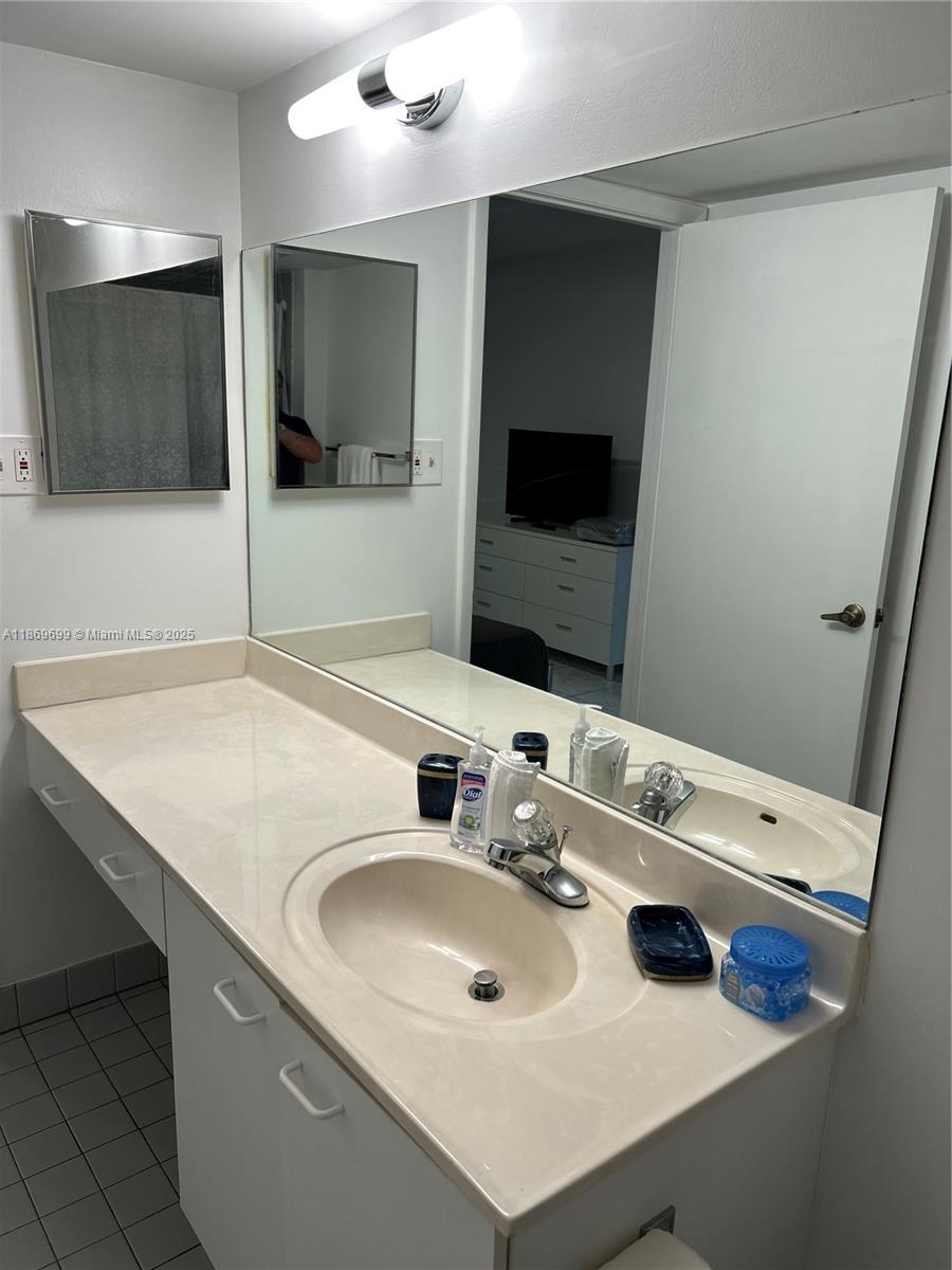 17801 North Bay Road, Unit 203 Sunny Isles Beach, FL 33160 - Photo 14 of 23 a bathroom with a sink and a mirror