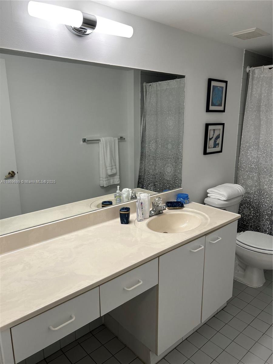 17801 North Bay Road, Unit 203 Sunny Isles Beach, FL 33160 - Photo 15 of 23 a view of bathroom with a sink and a toilet