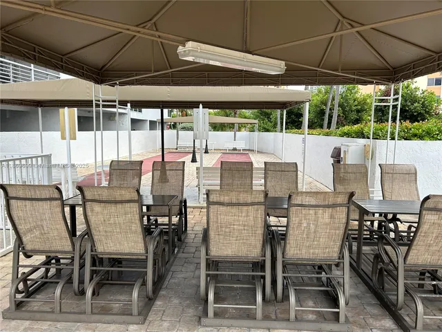 a view of an outdoor dining space with furniture