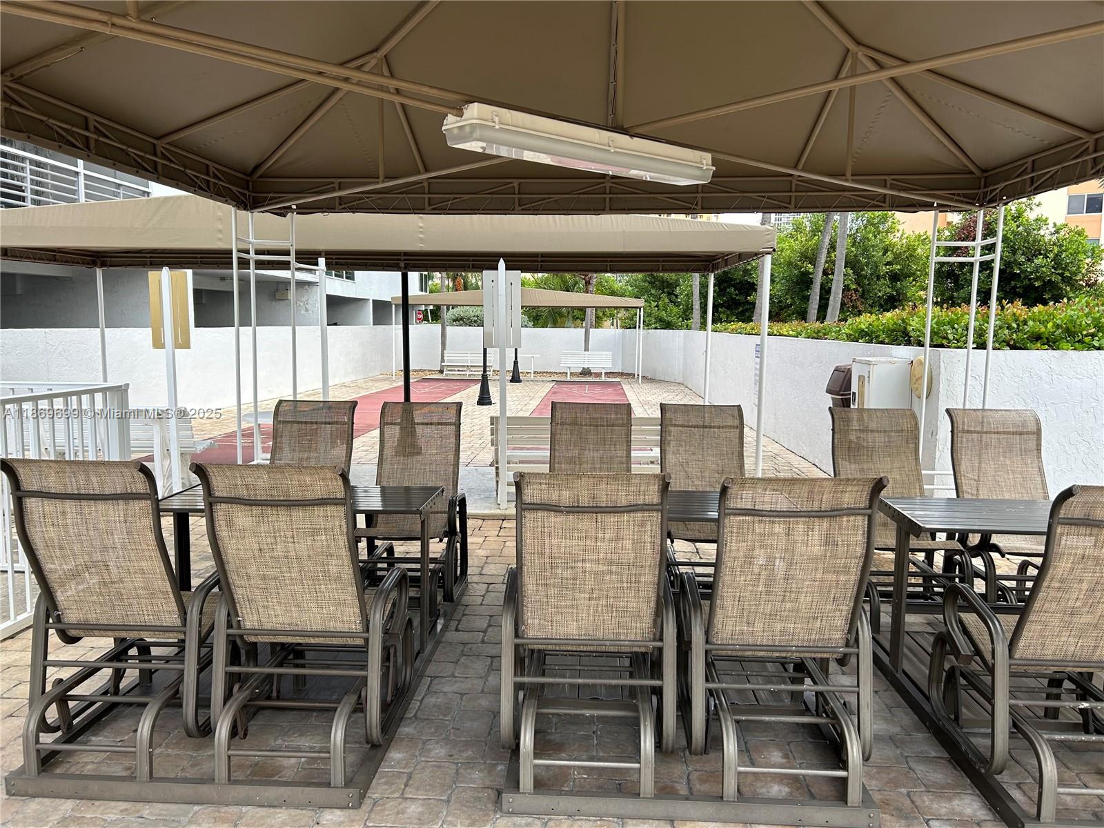 17801 North Bay Road, Unit 203 Sunny Isles Beach, FL 33160 - Photo 17 of 23 a view of an outdoor dining space with furniture