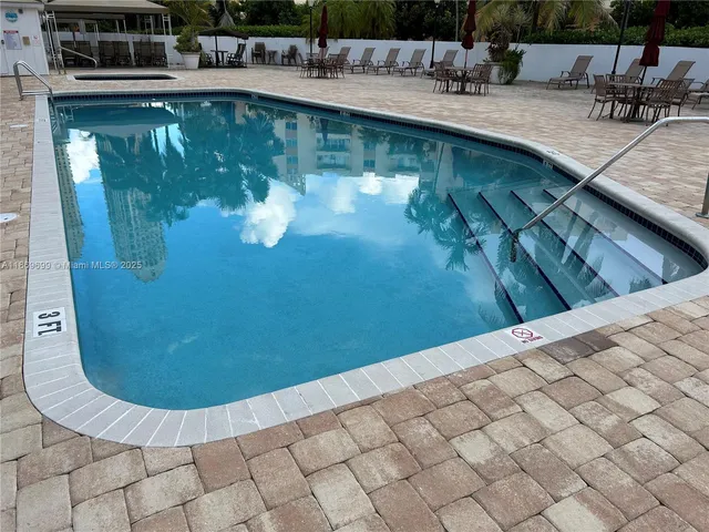 a view of a swimming pool with outdoor seating