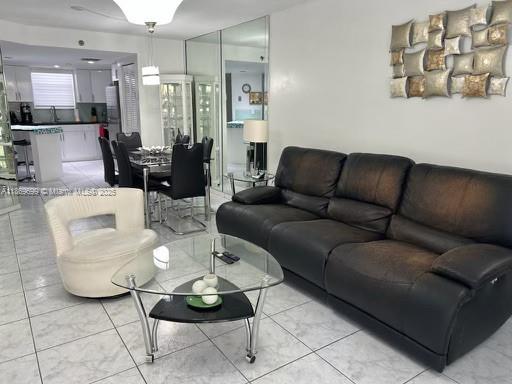 17801 North Bay Road, Unit 203 Sunny Isles Beach, FL 33160 - Photo 2 of 23 a living room with furniture and wooden floor