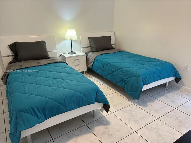 a bedroom with a bed and lamp