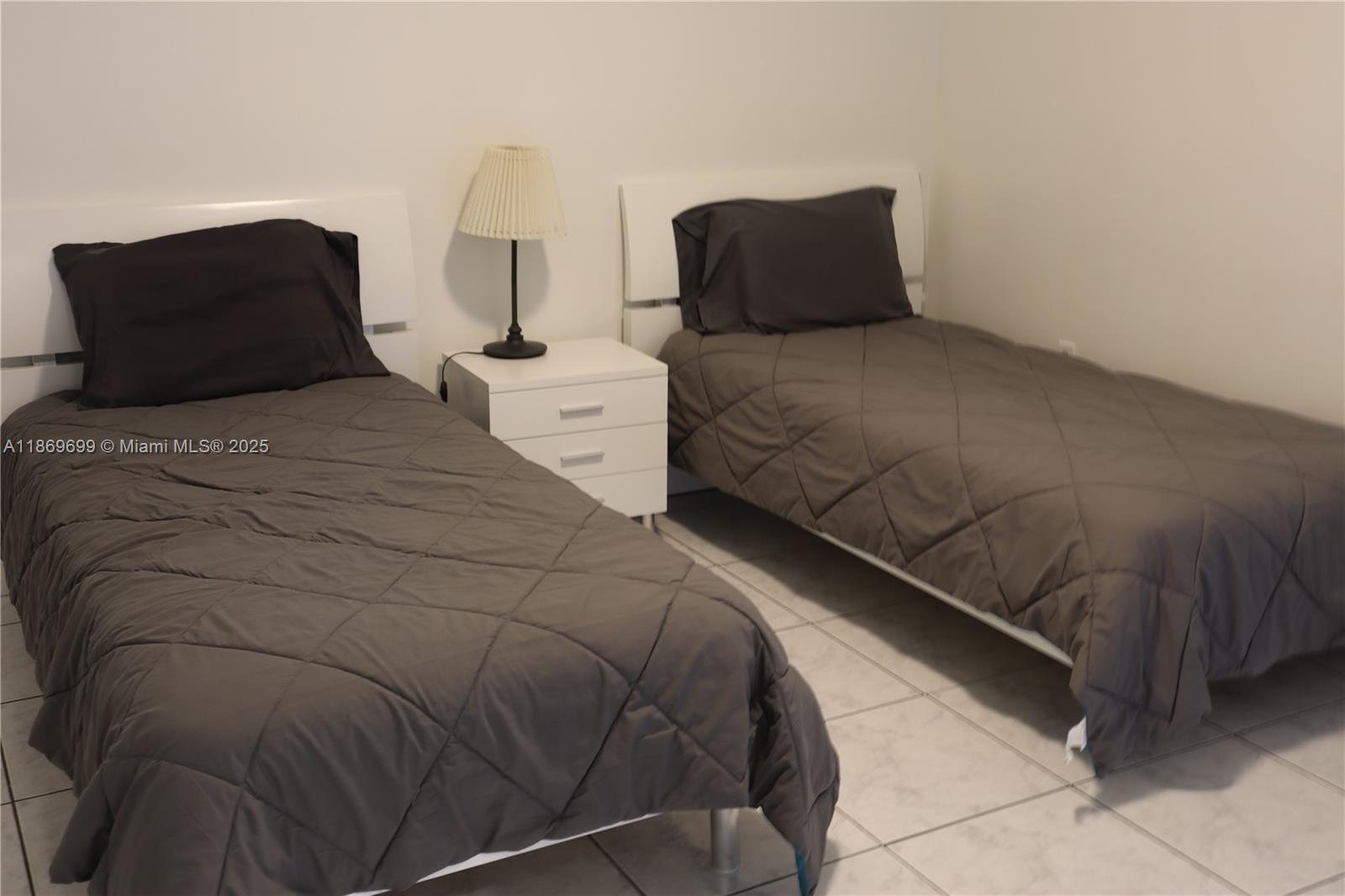 17801 North Bay Road, Unit 203 Sunny Isles Beach, FL 33160 - Photo 5 of 23 a bedroom with a bed and window