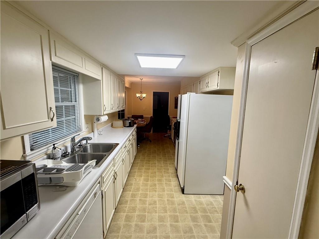 5705 Orly Terrace Atlanta, GA 30349 - Photo 12 of 42 a kitchen with a refrigerator and a sink
