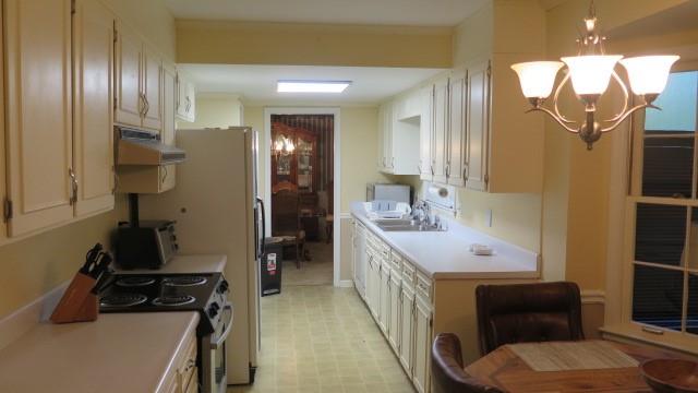 5705 Orly Terrace Atlanta, GA 30349 - Photo 15 of 42 a kitchen with a sink appliances and cabinets