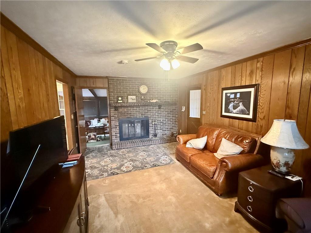 5705 Orly Terrace Atlanta, GA 30349 - Photo 16 of 42 a living room with furniture a lamp and a fireplace
