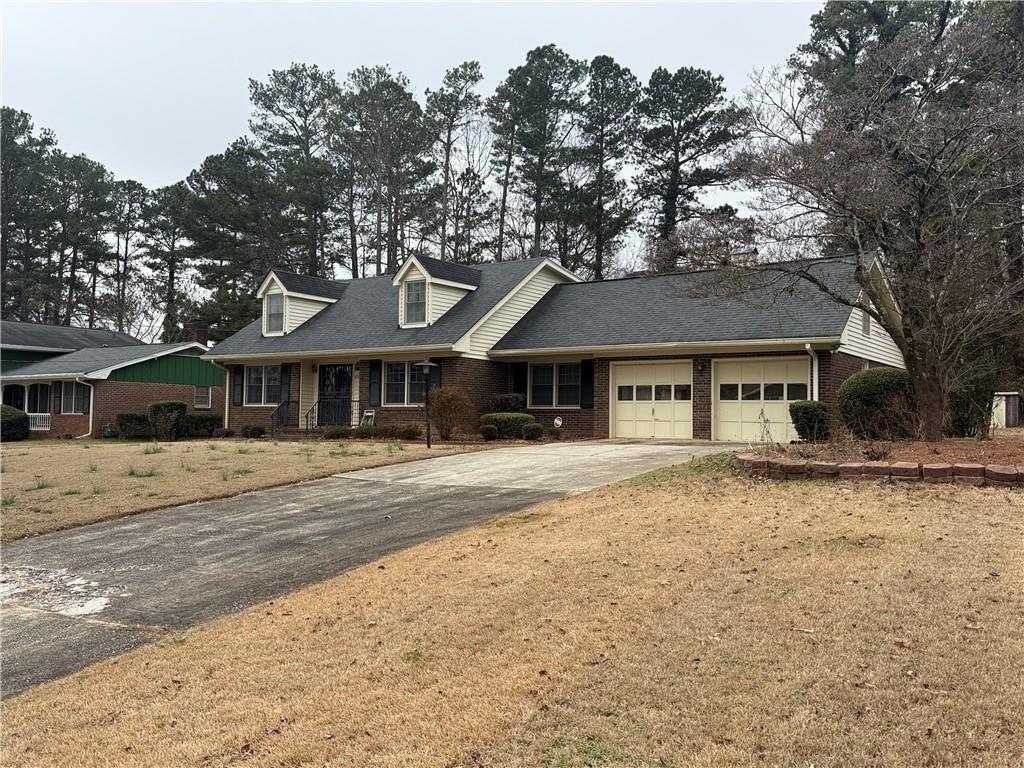 5705 Orly Terrace Atlanta, GA 30349 - Photo 3 of 42 a front view of a house with a garden