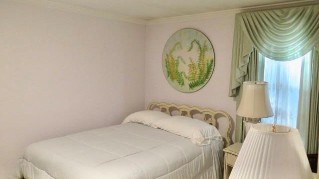 5705 Orly Terrace Atlanta, GA 30349 - Photo 31 of 42 a bedroom with a bed and a mirror